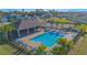 A clear view of the community pool with chairs and palm trees surrounding it at 5430 Pine Lilly Dr, St Cloud, FL 34771