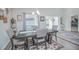 Dining room with a dark wood table, gray upholstered chairs, and a stylish patterned rug at 5430 Pine Lilly Dr, St Cloud, FL 34771