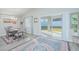 Dining area showcasing sliding glass doors leading to the backyard and a stylish area rug at 5430 Pine Lilly Dr, St Cloud, FL 34771