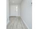 Bright foyer with gray wood-look floors leads into a neutrally painted home with white trim at 5430 Pine Lilly Dr, St Cloud, FL 34771