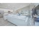 Open-concept living space with lots of natural light, white sofa, and view of the kitchen at 5430 Pine Lilly Dr, St Cloud, FL 34771