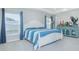 Main bedroom has a ceiling fan, windows with blue curtains, a striped comforter, and display cabinet at 5430 Pine Lilly Dr, St Cloud, FL 34771