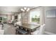 Open-concept dining room with a modern table set and natural light at 5563 Maddie Dr, Haines City, FL 33844