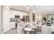 Bright kitchen featuring white cabinets, stainless appliances, granite countertops and an island with stools at 5563 Maddie Dr, Haines City, FL 33844