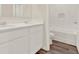 Bright bathroom featuring double sink vanity, white cabinets, and a shower and tub combination at 5844 Galloping Dr, Apopka, FL 32712