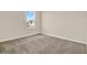 Neutral bedroom showcasing plush carpet, natural light from a large window, and a closet at 5844 Galloping Dr, Apopka, FL 32712