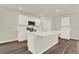 Bright kitchen with stainless steel appliances, white cabinetry, and a center island at 5844 Galloping Dr, Apopka, FL 32712