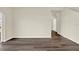 Spacious living room featuring wood-look flooring, base trim, and neutral paint at 5844 Galloping Dr, Apopka, FL 32712