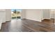 Open living room featuring wood-look flooring and sliding glass doors to the backyard at 5844 Galloping Dr, Apopka, FL 32712