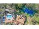 Top-down aerial view of a tennis court, pool, and a hot tub along with the community buildings at 615 Richland Ct # 61, Altamonte Springs, FL 32714