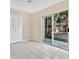 Bright bedroom featuring tile floors, a ceiling fan, closet, and sliding glass doors to the outside patio at 615 Richland Ct # 61, Altamonte Springs, FL 32714