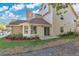 Exterior view of the home showing the back of the house, patio, and some landscaping in the yard at 615 Richland Ct # 61, Altamonte Springs, FL 32714