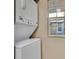 The laundry room has a full size, stacked washer and dryer near a window that provides natural light at 615 Richland Ct # 61, Altamonte Springs, FL 32714