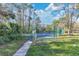 Fenced tennis court surrounded by lush trees and greenery in a well-maintained area at 615 Richland Ct # 61, Altamonte Springs, FL 32714