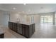 Kitchen island with granite countertop, stainless steel dishwasher, and tile flooring at 6598 Lullaby Way, Mascotte, FL 34753
