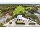 A scenic aerial view of a modern home with a golf course, railroad, and lush greenery in the neighborhood at 720 N Pennsylvania Ave, Winter Park, FL 32789