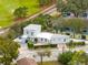 Eye-level aerial view of the home showing a fenced yard and proximity to the railway and surrounding landscape at 720 N Pennsylvania Ave, Winter Park, FL 32789