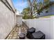 This backyard has pavers, a white fence, and outdoor seating, creating a tranquil and private outdoor area at 720 N Pennsylvania Ave, Winter Park, FL 32789