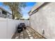 Cozy patio area featuring pavers, a white fence, and comfortable seating, perfect for outdoor entertaining at 720 N Pennsylvania Ave, Winter Park, FL 32789