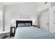 Bright bedroom with a bed, side tables with lamps, and neutral walls, creating a cozy and inviting space at 720 N Pennsylvania Ave, Winter Park, FL 32789