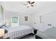 This bedroom features neutral walls, a comfortable bed, dark dresser and side tables, and fan at 720 N Pennsylvania Ave, Winter Park, FL 32789