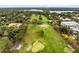 Scenic aerial shot of the golf course, surrounded by lush greenery, lakes and residential buildings at 720 N Pennsylvania Ave, Winter Park, FL 32789