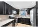 Contemporary kitchen featuring stainless steel appliances, sleek black cabinetry, and bright white countertops at 720 N Pennsylvania Ave, Winter Park, FL 32789