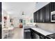Open layout showing a kitchen with dark cabinets and a view of the living room and dining space at 720 N Pennsylvania Ave, Winter Park, FL 32789