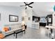 Open-concept living room with modern furniture, a ceiling fan, and an open view into the modern kitchen at 720 N Pennsylvania Ave, Winter Park, FL 32789