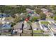 Aerial view of a suburban home highlighting its backyard, roof, and location within a neighborhood with mature trees at 7244 Somersworth Dr, Orlando, FL 32835