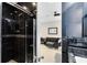 Modern bathroom featuring a shower with black tile and a mosaic accent, adjacent to a cozy living space at 726 N Pennsylvania Ave, Winter Park, FL 32789