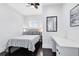 Bright bedroom with white walls, a plaid bedspread, and dark wood floors at 726 N Pennsylvania Ave, Winter Park, FL 32789