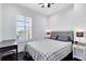 Cozy bedroom with a plaid bedspread, white walls, and dark wood floors at 726 N Pennsylvania Ave, Winter Park, FL 32789