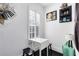 A quaint dining area with a small table and two stools, illuminated by a stylish lamp at 726 N Pennsylvania Ave, Winter Park, FL 32789