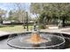 Beautiful fountain with statue in a park setting, surrounded by lush greenery, benches, and shade trees at 726 N Pennsylvania Ave, Winter Park, FL 32789