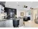 Modern kitchen featuring stainless steel appliances, a black marble backsplash and a stylish breakfast bar at 726 N Pennsylvania Ave, Winter Park, FL 32789
