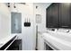 Functional laundry room with modern appliances and sleek black cabinets for ample storage at 726 N Pennsylvania Ave, Winter Park, FL 32789
