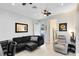 Inviting living room adjacent to a kitchen, featuring a comfortable black sofa and stylish decor at 726 N Pennsylvania Ave, Winter Park, FL 32789