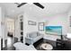 Cozy living room with modern decor, including a light blue sofa and a flat-screen TV at 726 N Pennsylvania Ave, Winter Park, FL 32789