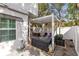 Brick patio with a white pergola and storage benches, offering an inviting outdoor space for relaxation and entertainment at 726 N Pennsylvania Ave, Winter Park, FL 32789