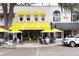 Charming outdoor restaurant with bright yellow awnings and umbrellas, offering a delightful al fresco dining experience at 726 N Pennsylvania Ave, Winter Park, FL 32789