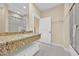 Elegant bathroom featuring granite countertops, modern fixtures and a glass shower at 7663 Recife Dr, Kissimmee, FL 34747
