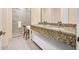 Bright bathroom with granite countertops, a double sink vanity and glass enclosed shower at 7663 Recife Dr, Kissimmee, FL 34747