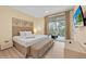 Comfortable bedroom featuring a king bed, balcony access and a mounted flatscreen television at 7663 Recife Dr, Kissimmee, FL 34747