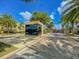 Community entrance with water feature and mature palm trees on a bright, sunny day at 7663 Recife Dr, Kissimmee, FL 34747