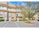 Charming multi-story townhome featuring a private balcony and well-manicured landscaping at 7663 Recife Dr, Kissimmee, FL 34747