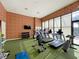 Brightly lit gym with brick accent wall and an array of modern exercise equipment at 7663 Recife Dr, Kissimmee, FL 34747