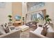 Spacious living room with high ceilings, large windows, and stylish neutral decor at 7663 Recife Dr, Kissimmee, FL 34747