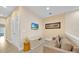 Cozy living space features neutral tones, with a mounted TV and access to natural light at 7663 Recife Dr, Kissimmee, FL 34747