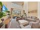 Bright living room with high ceilings, comfortable seating, and a large sliding door to the outdoor patio at 7663 Recife Dr, Kissimmee, FL 34747